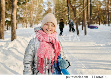 Cute cheerful girl with blue slide Cute cheerful girl with blue slide 113860180