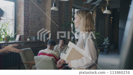 Man and woman business partners meeting in creative office shaking hands and talking. Professional meeting and successful start-up concept. Man and woman business partners meeting in creative office shaking hands and talking. Professional meeting and successful start-up concept. 113860258