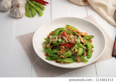Stir fried snow peas with minced pork in white plate.Thai style food. 113861413