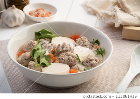 Clear soup with soy bean curd ,Minced Pork glass noodles and Vegetables in white bowl 113861419