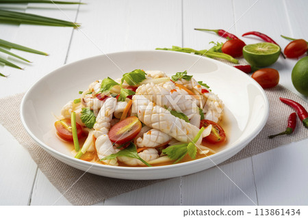 Thai Spicy Squid Salad,mixed squid with onion and tomato in chilli lime sauce in white plate.Thai food 113861434