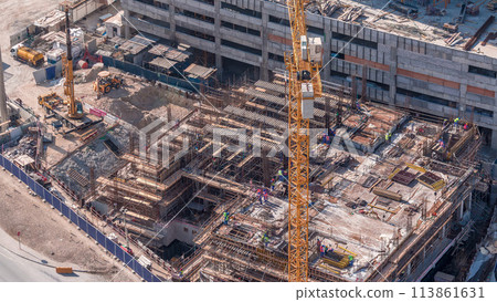 Aerial view of construction with special machines in Business Bay, Dubai timelapse 113861631