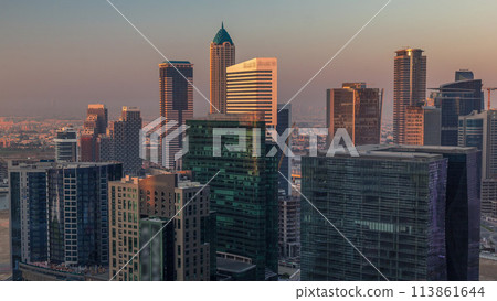 Dubai's business bay towers at morning aerial timelapse. Dubai's business bay towers at morning aerial timelapse. 113861644