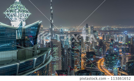 Panoramic aerial view of business bay towers in Dubai night timelapse. 113861652