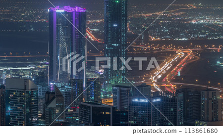 Panoramic aerial view of business bay towers in Dubai night timelapse. Panoramic aerial view of business bay towers in Dubai night timelapse. 113861680