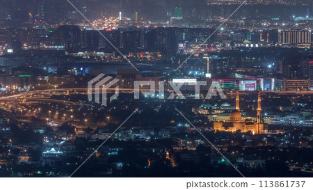 Aerial view of neighborhood Zabeel and Dubai creek with typical old and modern buildings night timelapse. 113861737
