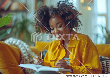 happy dark-skinned woman drawing with pencils in colouring book happy dark-skinned woman drawing with pencils in colouring book 113861982
