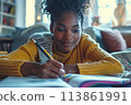 happy dark-skinned woman drawing with pencils in colouring book 113861991