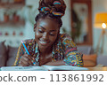 happy dark-skinned woman drawing with pencils in colouring book 113861992