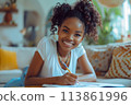 happy dark-skinned woman drawing with pencils in colouring book 113861996