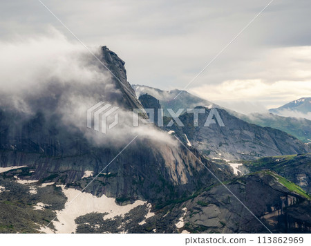 Low clouds and beautiful rockies. Dramatic fog among giant rocky Low clouds and beautiful rockies. Dramatic fog among giant rocky 113862969