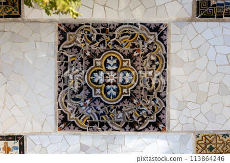 Colorful mosaic tiles at Guell Park. Broken tiles mosaic pattern. UNESCO World Heritage Site, Barcelona, Spain Colorful mosaic tiles at Guell Park. Broken tiles mosaic pattern. UNESCO World Heritage Site, Barcelona, Spain 113864246
