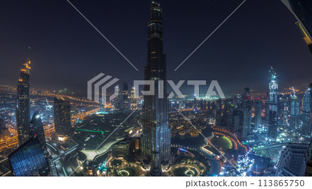 Panoramic skyline view of Dubai downtown with mall, fountains and Burj Khalifa aerial night to day timelapse 113865750