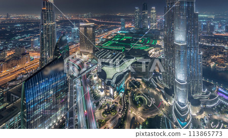 Panoramic skyline view of Dubai downtown with mall, fountains and Burj Khalifa aerial night timelapse 113865773