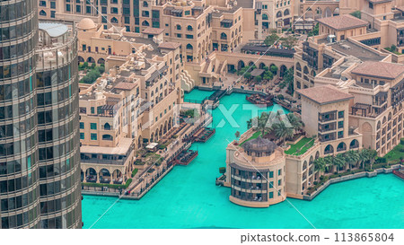 Dubai downtown with fountains area near mall and souk timelapse. Dubai downtown with fountains area near mall and souk timelapse. 113865804