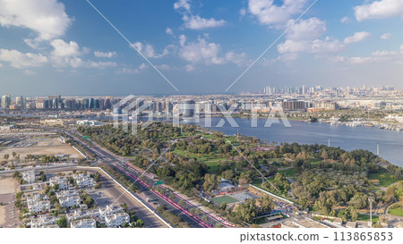 View of new modern buildings at sunny day in luxury Dubai city, United Arab Emirates Timelapse Aerial 113865853