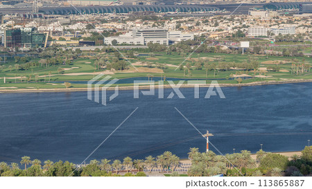 View of park near canal and buildings in luxury Dubai city, United Arab Emirates Timelapse Aerial 113865887