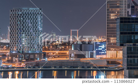 Bright night in Dubai near canal aerial timelapse 113866027