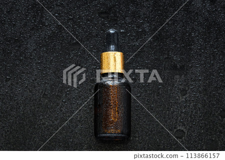 Serum dropper on wet stone background 113866157