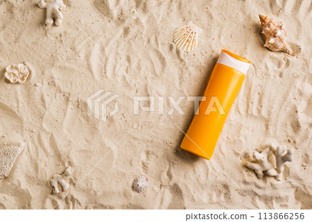 Sunscreen sunblock lotion on sandy beach 113866256
