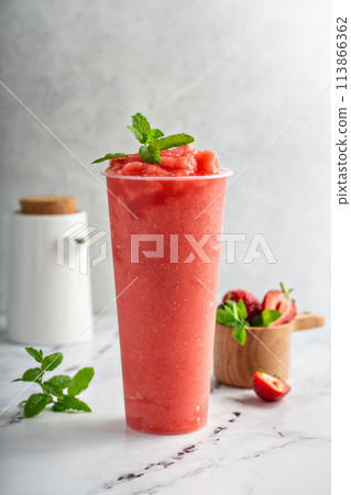 Strawberry watermelon smoothie or slushie in a tall cup 113866362