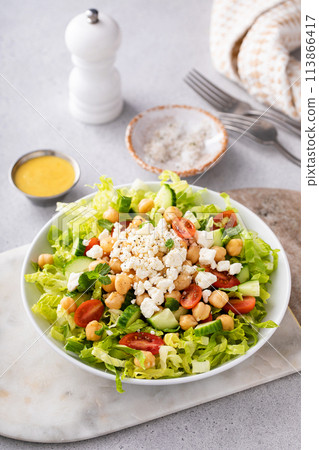 Healthy salad for lunch with fresh vegetables, chickpeas and feta 113866417