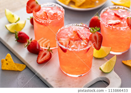 Strawberry margarita with lime, served with chips 113866433