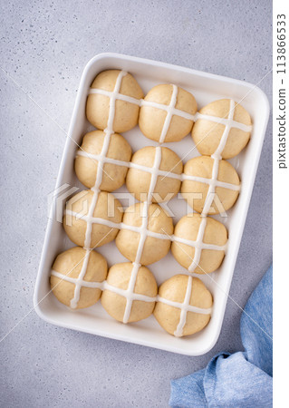 Hot cross buns ready to be baked in a pan with cross pattern 113866533