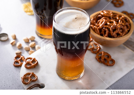 Black and tan cocktail with pale ale and dark stout beer, traditional stout cocktail Black and tan cocktail with pale ale and dark stout beer, traditional stout cocktail 113866552