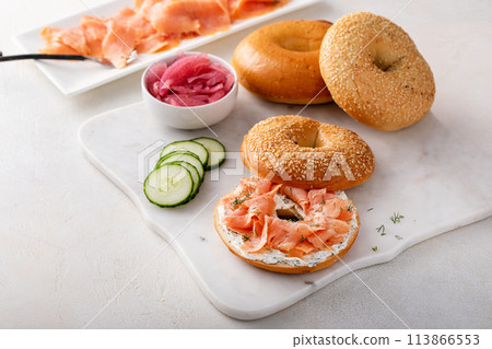 Bagels served with cream cheese and smoked salmon, sesame lox bagels 113866553