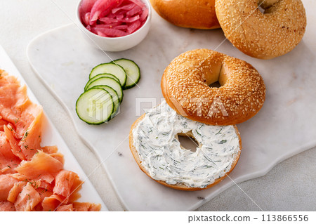 Bagels served with cream cheese and smoked salmon, sesame lox bagels 113866556