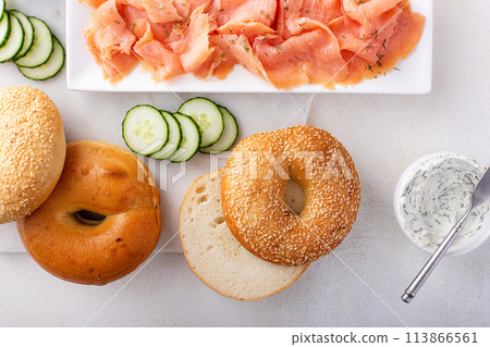 Bagels served with cream cheese and smoked salmon, sesame lox bagels 113866561