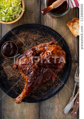 Half of smoked chicken with barbecue sauce served with salad and sauce 113866600