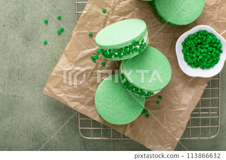 Green sandwich cookies with clover leaf sprinkles, dessert idea for Saint Patricks Day Green sandwich cookies with clover leaf sprinkles, dessert idea for Saint Patricks Day 113866632