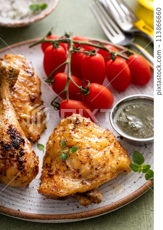 Roasted chicken thighs and drumsticks served with pesto sauce Roasted chicken thighs and drumsticks served with pesto sauce 113866660