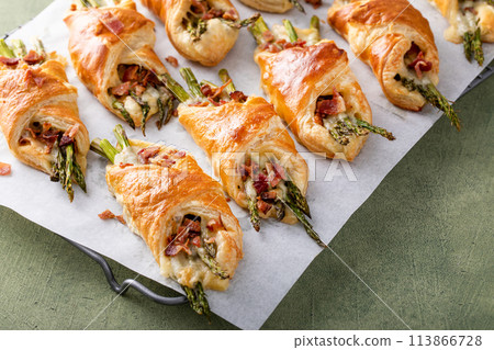 Asparagus appetizers wrapped in puff pastry with melted cheese Asparagus appetizers wrapped in puff pastry with melted cheese 113866728