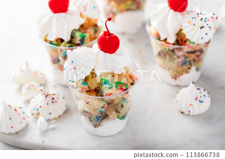 Funfetti cake in a cup with whipped cream and cherry on top 113866738