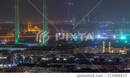 Dubai Frame with Zabeel Masjid mosque illuminated at night timelapse. 113866837