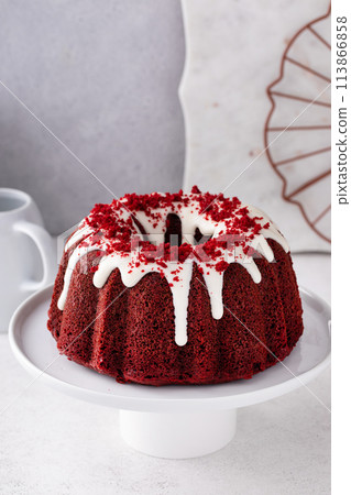 Red velvet cake with cream cheese glaze and red velvet crumbs on top 113866858