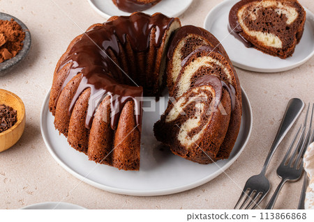 Marbled bundt cake sliced on a plate, chocolate and vanilla marble cake with chocolate glaze Marbled bundt cake sliced on a plate, chocolate and vanilla marble cake with chocolate glaze 113866868