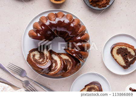 Marbled bundt cake sliced on a plate, chocolate and vanilla marble cake with chocolate glaze Marbled bundt cake sliced on a plate, chocolate and vanilla marble cake with chocolate glaze 113866869