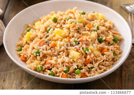 Pineapple fried rice with eggs, carrots and peas 113866877