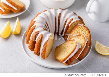 Lemon bundt cake sliced on a plate with powdered sugar glaze Lemon bundt cake sliced on a plate with powdered sugar glaze 113866901
