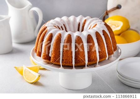 Lemon bundt cake on a cake stand with powdered sugar glaze Lemon bundt cake on a cake stand with powdered sugar glaze 113866911