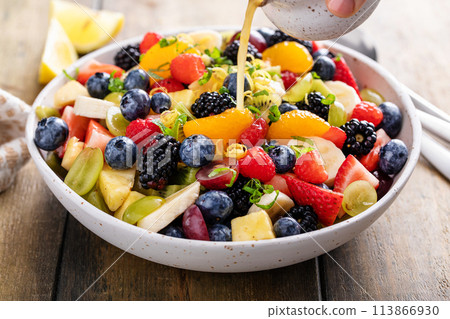 Healthy and colorful fruit salad with orange dressing and fresh mint Healthy and colorful fruit salad with orange dressing and fresh mint 113866930