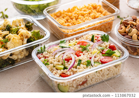Healthy vegan meal prep with roasted vegetables, cooked lentils, couscous salad and nuts 113867032