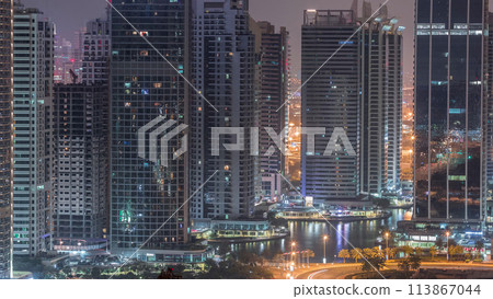 Residential and office buildings in Jumeirah lake towers district night to day timelapse in Dubai 113867044