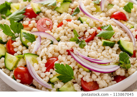 Pearl couscous salad with fresh vegetables and herbs, healthy side dish idea Pearl couscous salad with fresh vegetables and herbs, healthy side dish idea 113867045