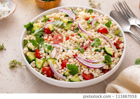 Pearl couscous salad with fresh vegetables and herbs, healthy side dish idea Pearl couscous salad with fresh vegetables and herbs, healthy side dish idea 113867058