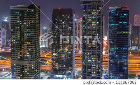 Residential and office buildings in Jumeirah lake towers district night timelapse in Dubai 113867062